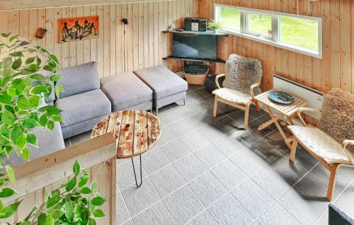 un salon avec un canapé, des chaises et une table dans l'établissement Holiday Home Gyvelvænget Glesborg Ii, à Fjellerup Strand