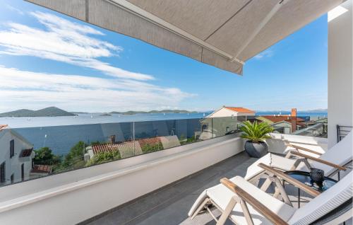 a balcony with chairs and a view of the ocean at Lovely Apartment In Drage With Sauna in Drage