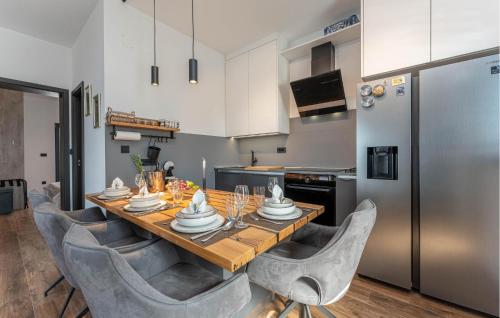 a kitchen with a wooden table with chairs around it at Lovely Apartment In Drage With Sauna in Drage