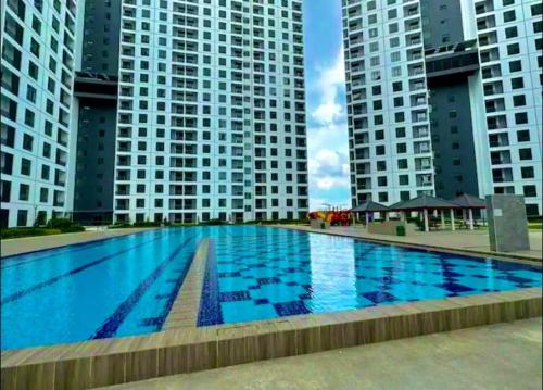 a large swimming pool in front of tall buildings at 3R2B KSL2 Midvalley Southkey Ikea Toppen Aeon in Johor Bahru