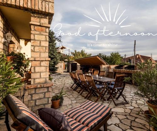 a patio with a table and chairs and a grill at Private Villa with indoor pool in Budapest