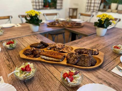 a table with a plate of meat and sausages at Private Villa with indoor pool in Budapest