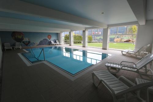 a large swimming pool in a house at Rosat 3 in Chateau-d'Oex