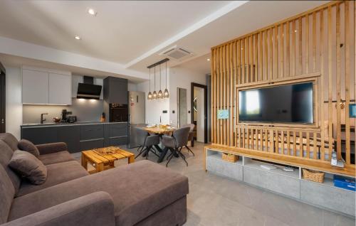 a living room with a couch and a tv at Cozy Apartment In Drage With Sauna in Drage