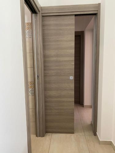 a hallway with a wooden door in a room at Giotera Village in Sciacca