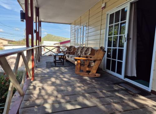 a porch with couches on the side of a house at Villa Tutilia in Willemstad