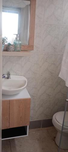 a bathroom with a sink and a toilet at Villa chava mesanine in Ibagué