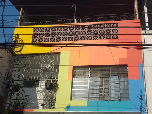 a brightly colored building with a window at Turpial inn in Cali