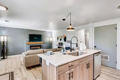 a kitchen and living room with a sink and a couch at Marmalade by Cloud Dream Homes in Salt Lake City