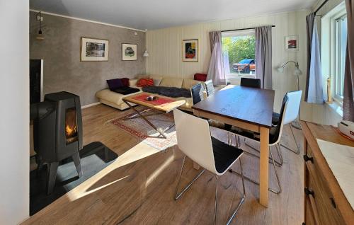 a living room with a table and a fireplace at 1 Bedroom Amazing Apartment In Vestby in Vestby