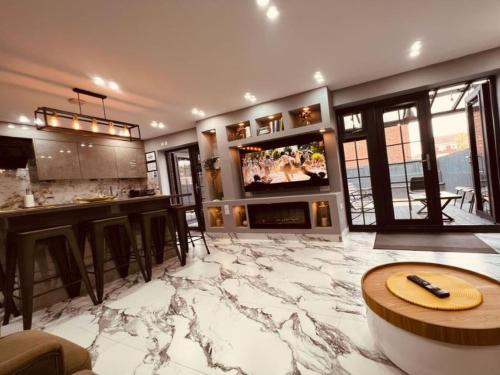 a living room with a marble floor and a tv at Urban Escape 4BedRoom House- With Free private Parking - Birmingham City in Birmingham