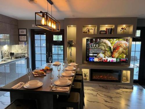 a dining room with a table and a fireplace at Urban Escape 4BedRoom House- With Free private Parking - Birmingham City in Birmingham