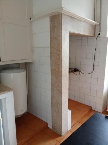 a bathroom with a pillar in the middle of a room at Amoreiras Lisbon Apartments in Lisbon