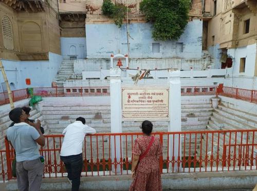 a group of people standing in front of a fountain at Pushkarni Home Stay in Varanasi