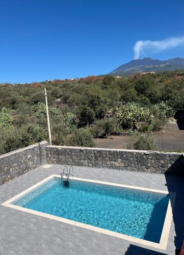 a swimming pool in the middle of a patio at Casa Perla dell'Etna in Ragalna