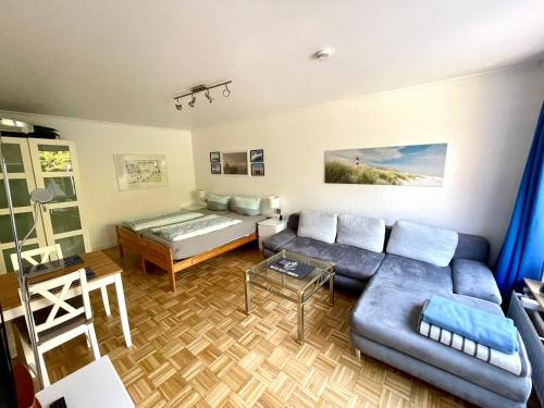 a living room with a couch and a bed at Ferienwohnung Bach in Travemünde in Lübeck