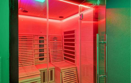 a glass shower with red lights in a bathroom at Luxusvilla Mit Kegelbahn in Bahrdorf