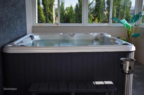 a jacuzzi tub in a bathroom with a window at Contemporary Villa in Atarfe with Private Pool and Mountain View in Atarfe