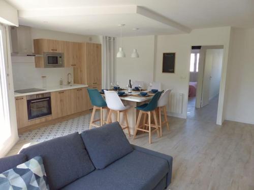 un salon avec un canapé bleu et une cuisine dans l'établissement Appartement avec 2 chambres et parking privé, à Lille