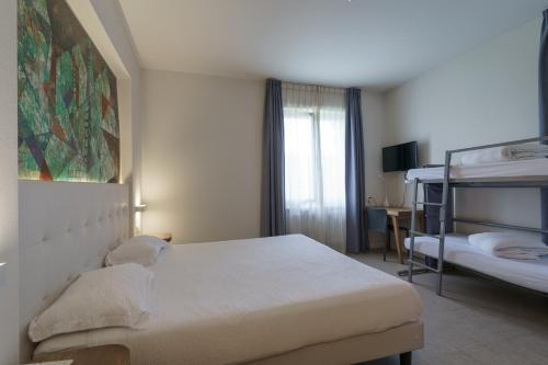 a bedroom with a bed and a bunk bed at Hotel Morgana in Mendrisio