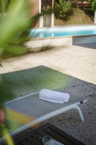 a towel sitting on a table next to a pool at Hotel Morgana in Mendrisio