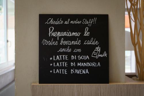 a chalkboard sign with a menu on a shelf at Hotel Morgana in Mendrisio