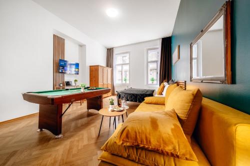 a living room with a couch and a pool table at Wagnerstays Royal Billiard Residence in Prague