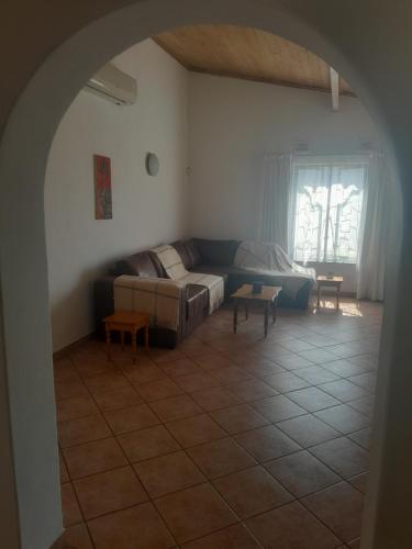 a living room with a couch and a table at Bed on 22 in Ballito
