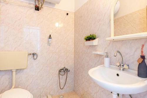 a bathroom with a toilet and a sink at Blue Maraçi 1 Beach Access nd Parking in Himare