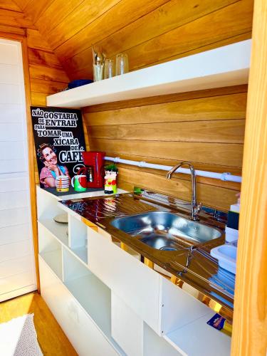 a kitchen with a sink and a counter top at Chalé Barril com cozinha in São Francisco do Sul