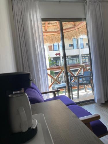 a hotel room with a view of a balcony at Hotel Pelecanus Suites Holbox in Holbox Island