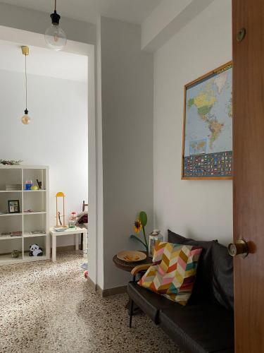 a living room with a couch and a map on the wall at APPARTAMENTO LA SPIAGGETTA in Foligno