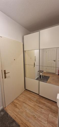 an empty room with a sliding glass door and a table at Zentrum Apartment - OLED TV - PS4 - Balkon - Parking in Chemnitz