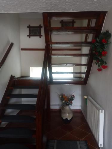 a staircase in a house with a vase of flowers at Lorsby- wędkarska oaza in Mrągowo