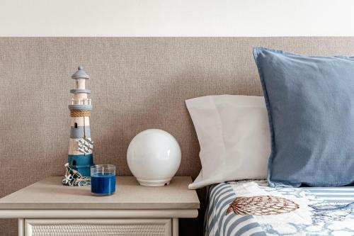 a bed with a lamp and a lighthouse on a table at Casa Mediterránia de Palamós amb piscina privada in Palamós