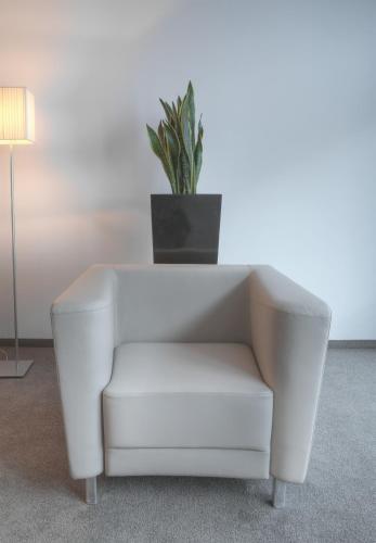 a white chair with a potted plant on top of it at Pepis Skihotel in Sankt Anton am Arlberg