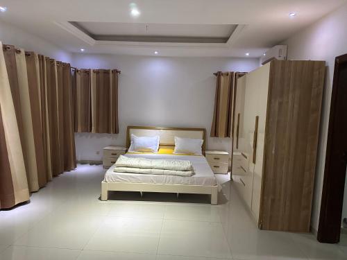 una camera da letto con un letto e delle tende marroni di Villa Somone a Dakar