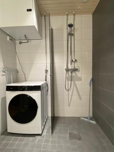 a microwave in a kitchen with a shower at First Aparthotel Olive in Rovaniemi
