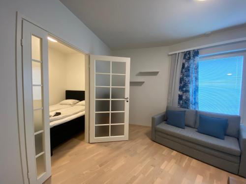 a bedroom with a bed and a sliding glass door at First Aparthotel Olive in Rovaniemi