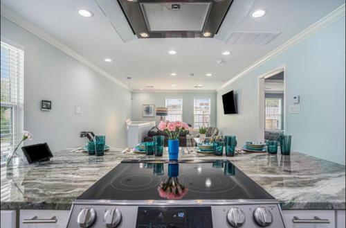 a kitchen with a stove top in a living room at Island Dreams Oasis Galveston Retreat in Galveston
