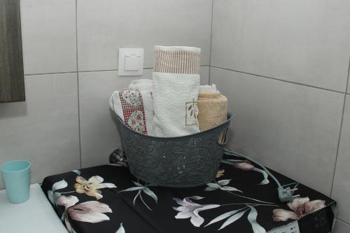 a bathroom with a basket of towels on a counter at Vagelis Nemea apartments in Neméa