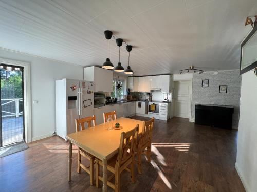 a kitchen and dining room with a table and chairs at Cosy House in Swedish Lapland in Överkalix