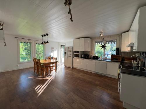 a kitchen and dining room with a table and chairs at Cosy House in Swedish Lapland in Överkalix