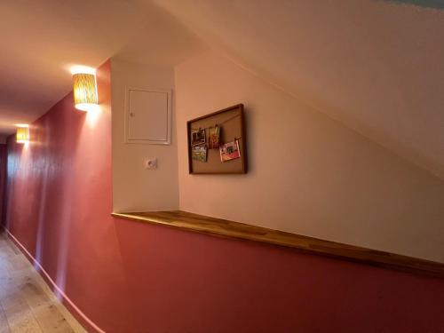 a room with a staircase with a shelf on the wall at Hypercenter lovely duplex with Terrace CLIM WIFI in Aix-en-Provence
