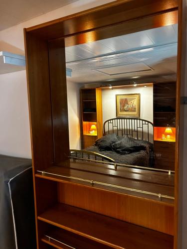 a bedroom with a bed in a large mirror at chez Jean in Le Boulou