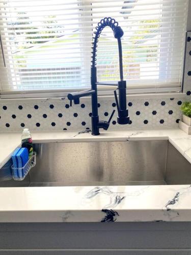 a kitchen sink with a faucet on top of it at Entire House in Old Fig Garden in Fresno