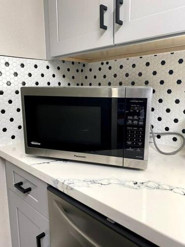 a microwave sitting on a counter in a kitchen at Entire House in Old Fig Garden in Fresno