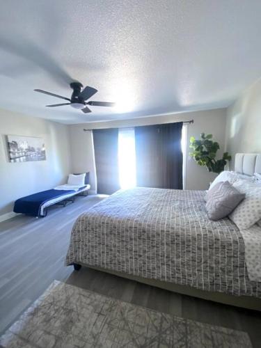 a bedroom with a bed and a ceiling fan at Entire House in Old Fig Garden in Fresno