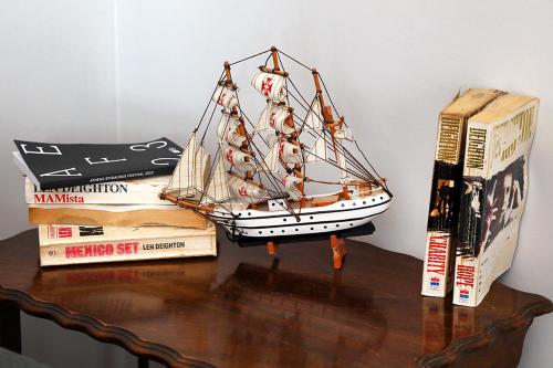 a toy boat sitting on top of books on a table at My Athens House in Athens