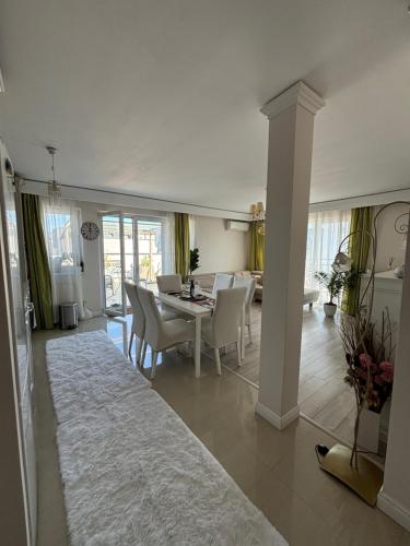 a dining room and living room with a table and chairs at SIBIU Bach Penthouse in Sibiu